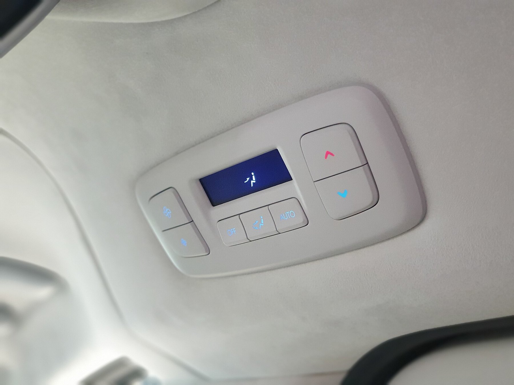 Interior roof controls in a passenger vehicle